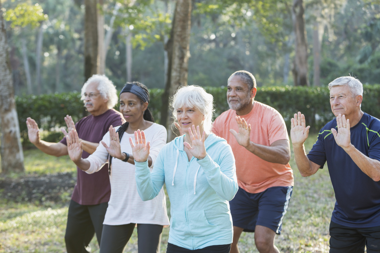 Group of people practicing Tai Chi outside